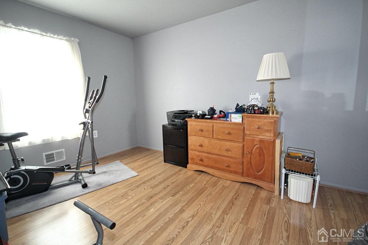 17 Higgins Road Old Bridge, NJ 08857 - Photo 20 of 30 a room with wooden floor and furniture