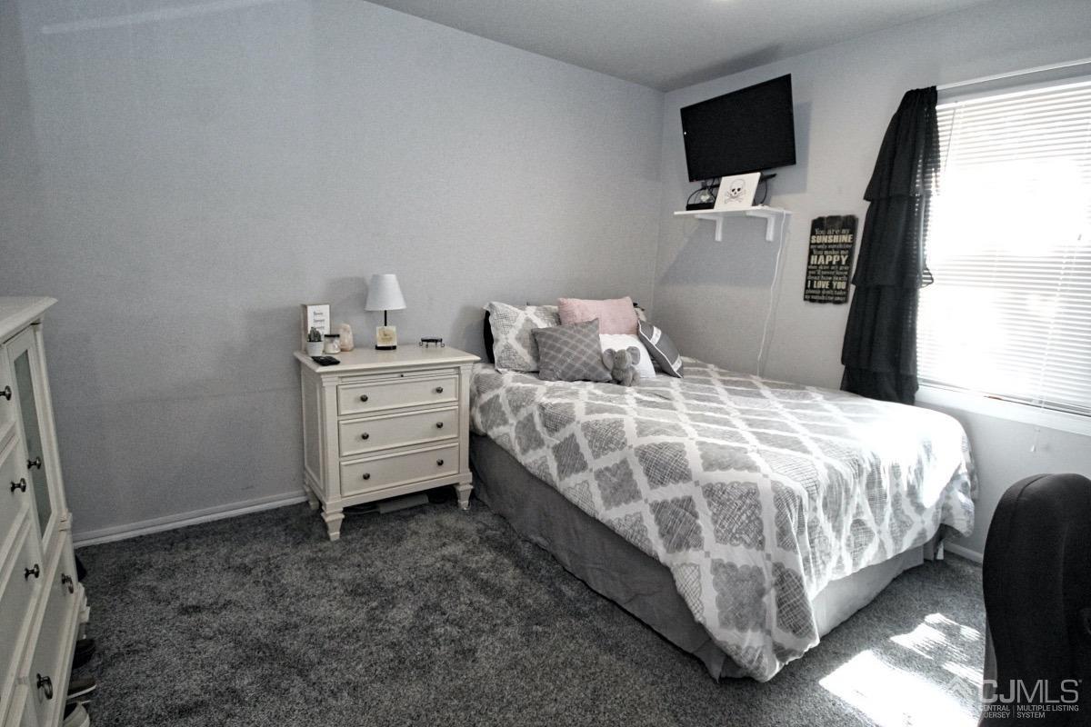 17 Higgins Road Old Bridge, NJ 08857 - Photo 22 of 30 a bedroom with a bed and flat screen tv