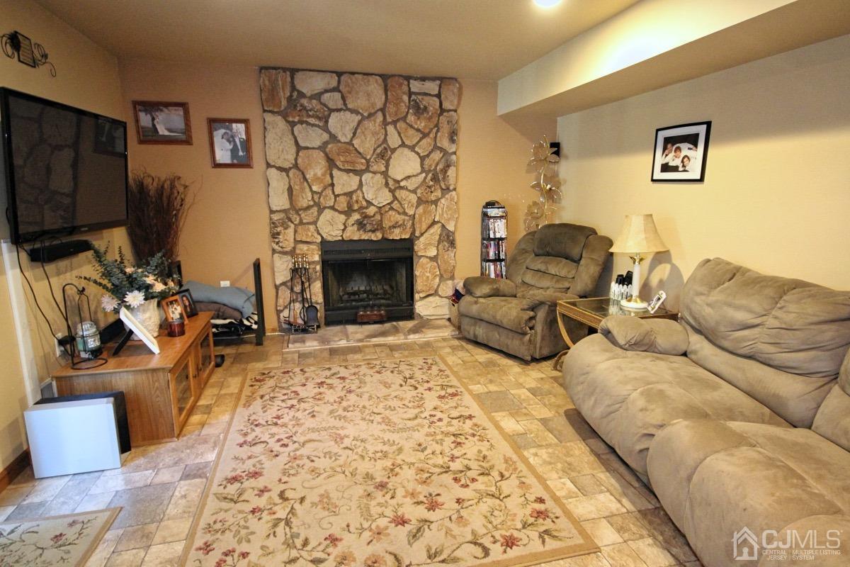 17 Higgins Road Old Bridge, NJ 08857 - Photo 23 of 30 a living room with furniture a rug and a fireplace