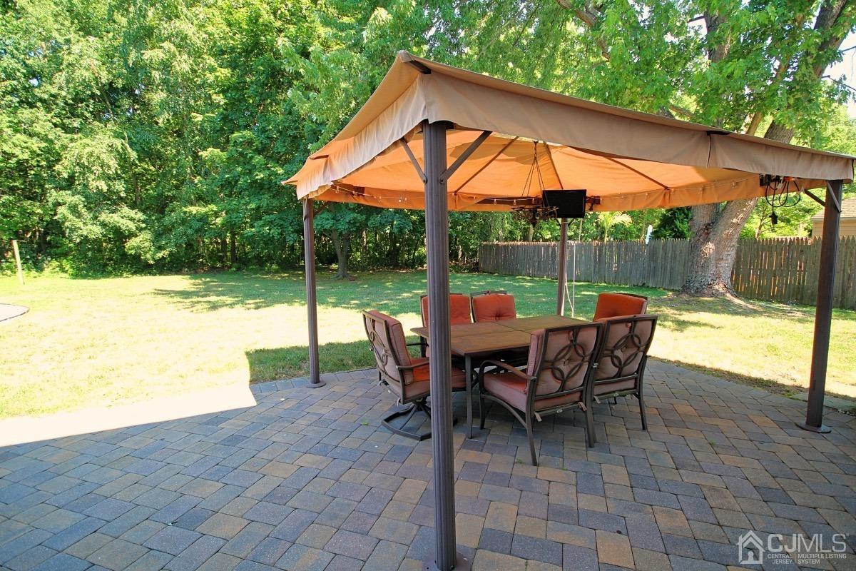 17 Higgins Road Old Bridge, NJ 08857 - Photo 27 of 30 a view of a patio with a table chairs and a backyard