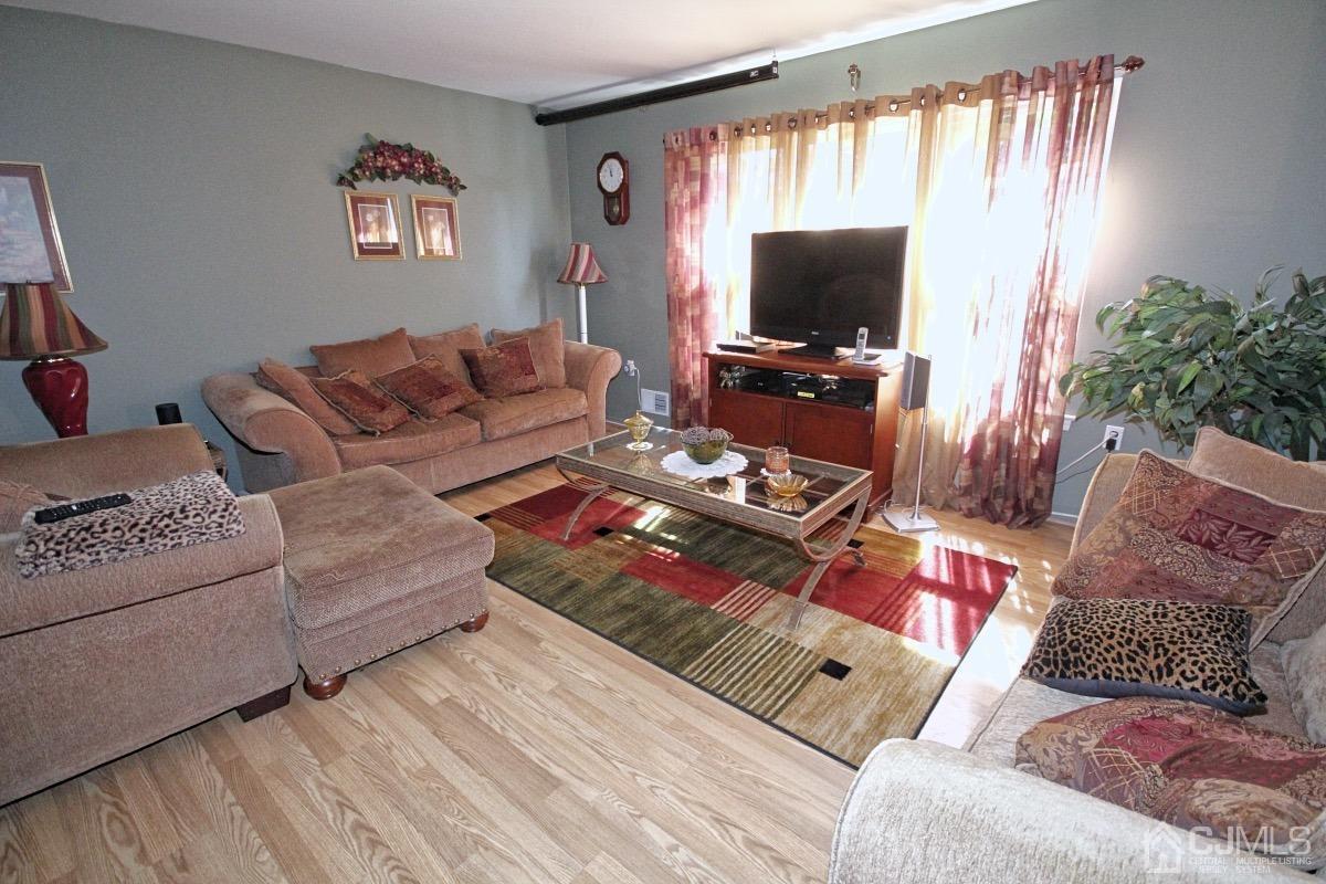 17 Higgins Road Old Bridge, NJ 08857 - Photo 6 of 30 a living room with furniture and a flat screen tv