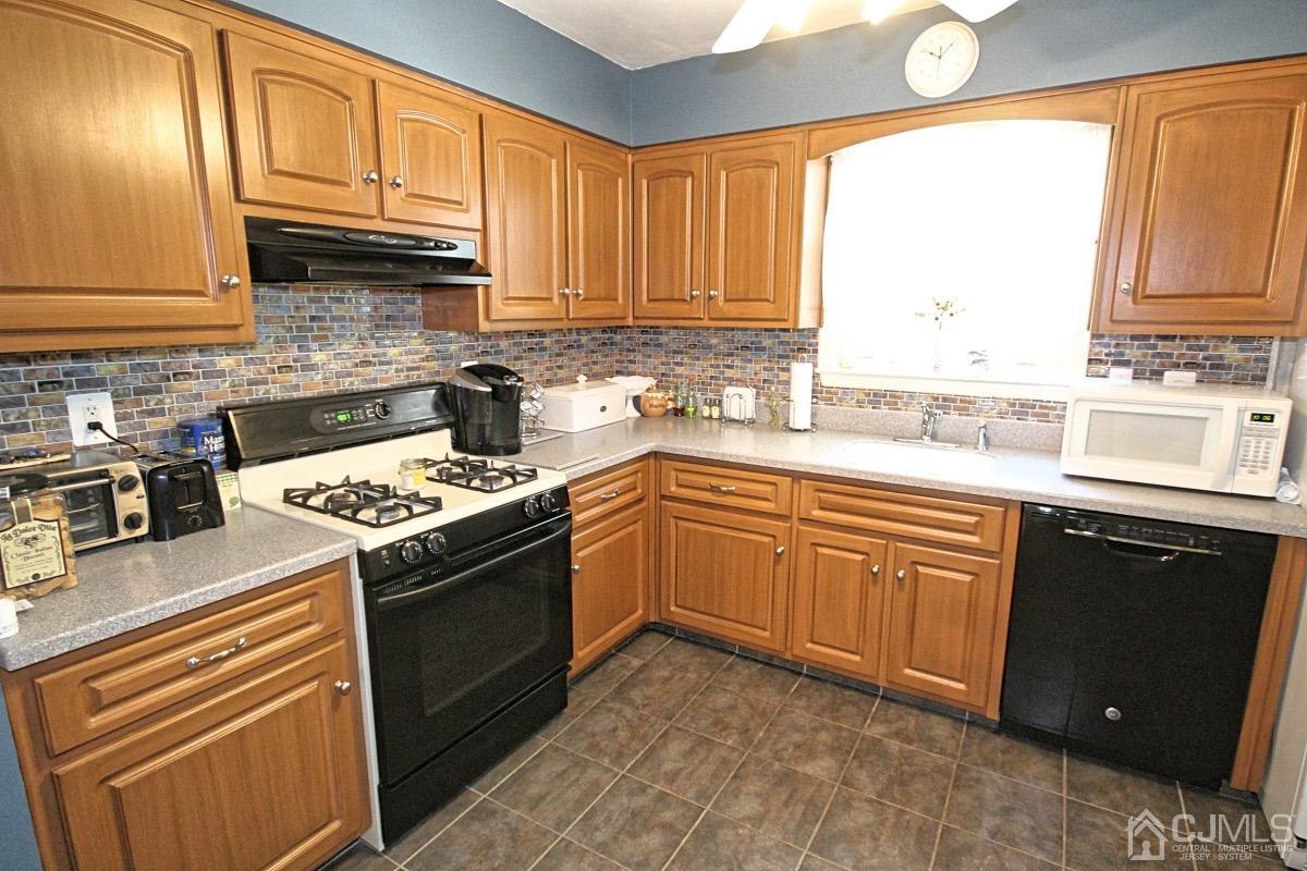 17 Higgins Road Old Bridge, NJ 08857 - Photo 10 of 30 a kitchen with granite countertop cabinets stainless steel appliances a sink and window