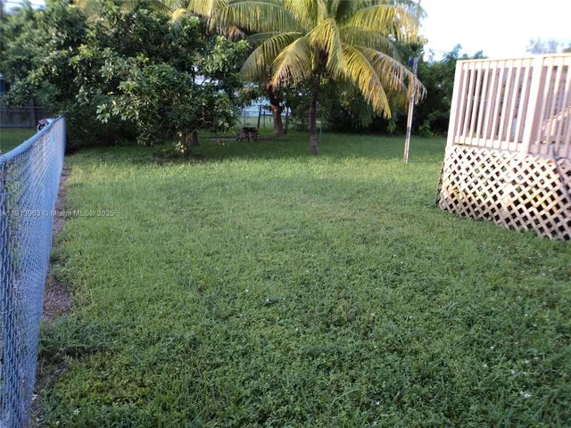 a view of outdoor space with deck and trees