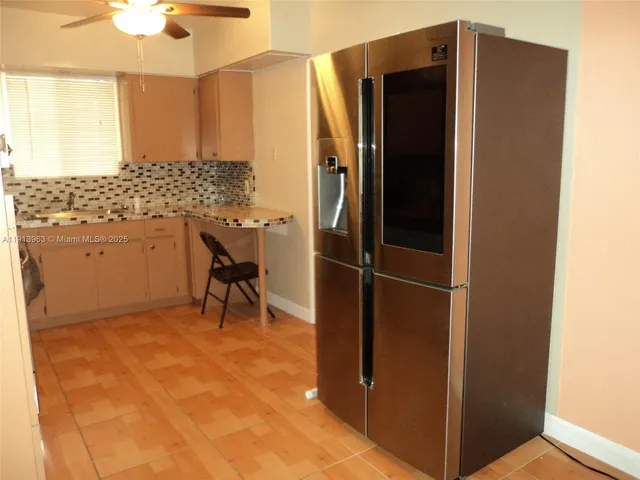 a bathroom with a sink and a refrigerator