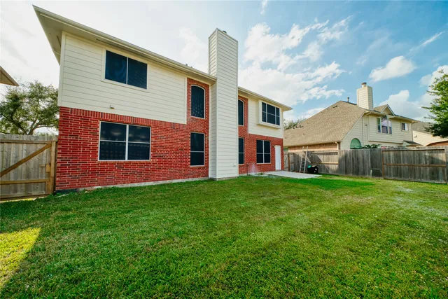 a backyard of a house with table and chairs