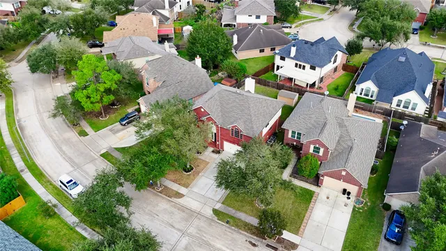 an aerial view of multiple houses with yard