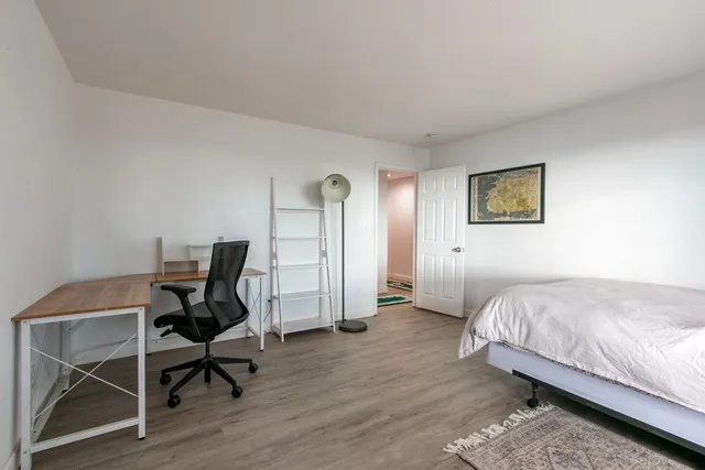 a bedroom with a bed and a desk