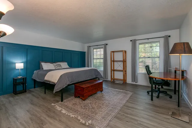 a bedroom with a bed and a table