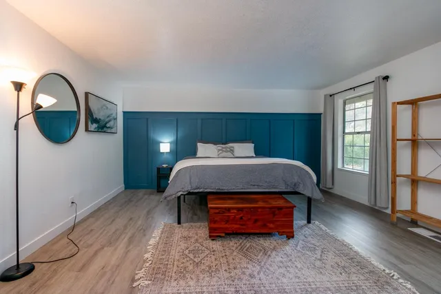 a bedroom with bed and window
