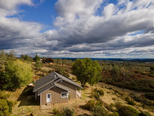 a view of a yard with wooden fence