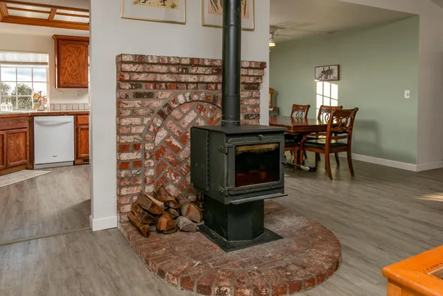 a living room with a fireplace and a wooden floor