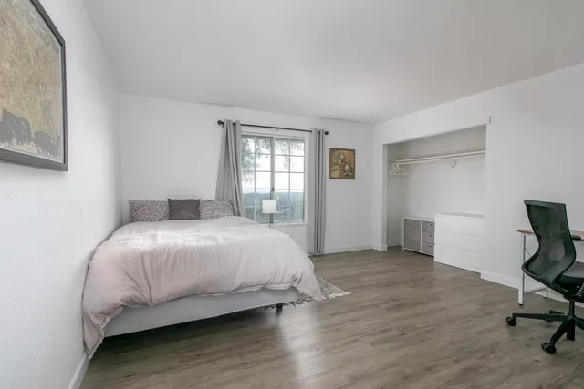 a bedroom with a bed and a window