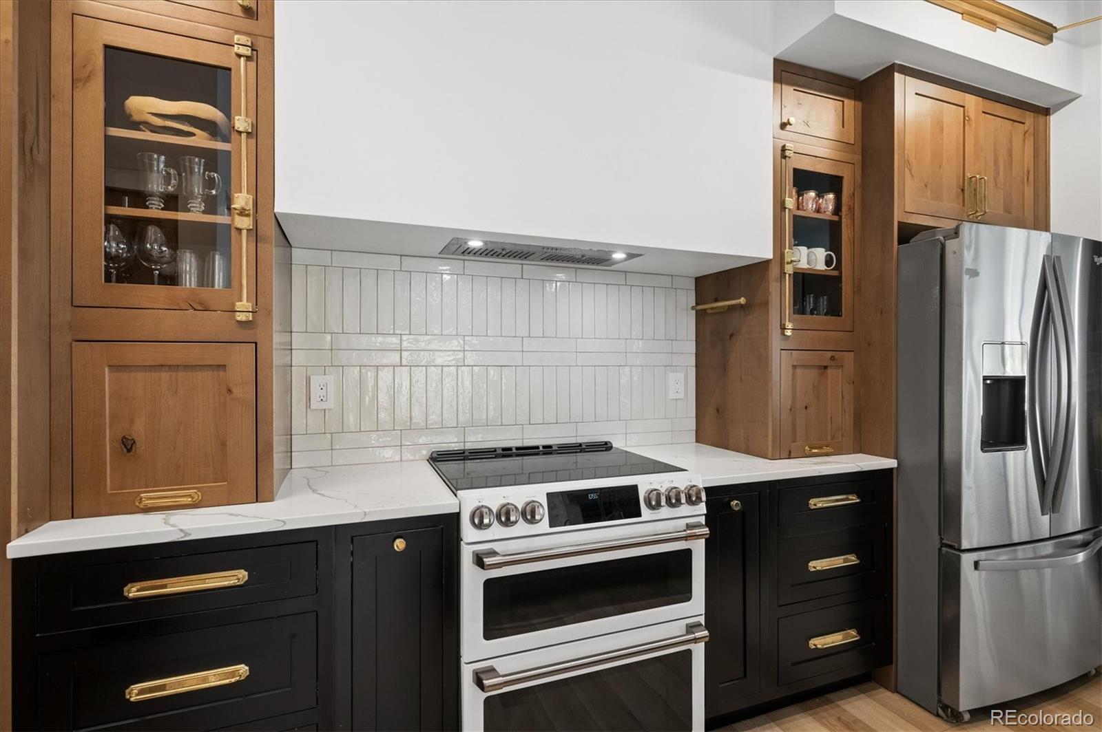 1633 Sinton Road Evergreen, CO 80439 - Photo 27 of 50 a kitchen with stainless steel appliances granite countertop a refrigerator and a stove