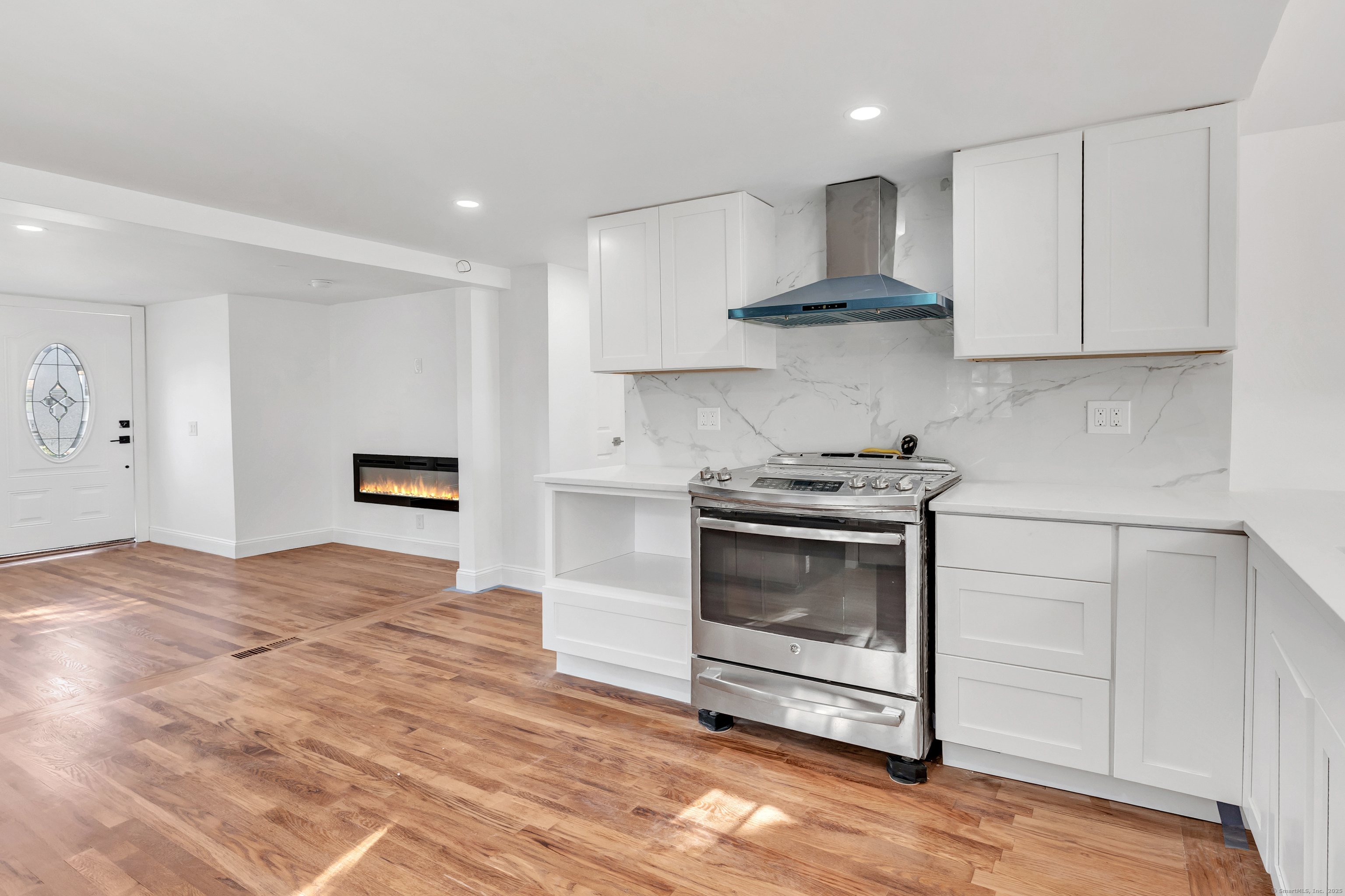 14 Fairview Avenue, Unit B Norwalk, CT 06850 - Photo 11 of 31 a kitchen with granite countertop a stove a sink and a white cabinets