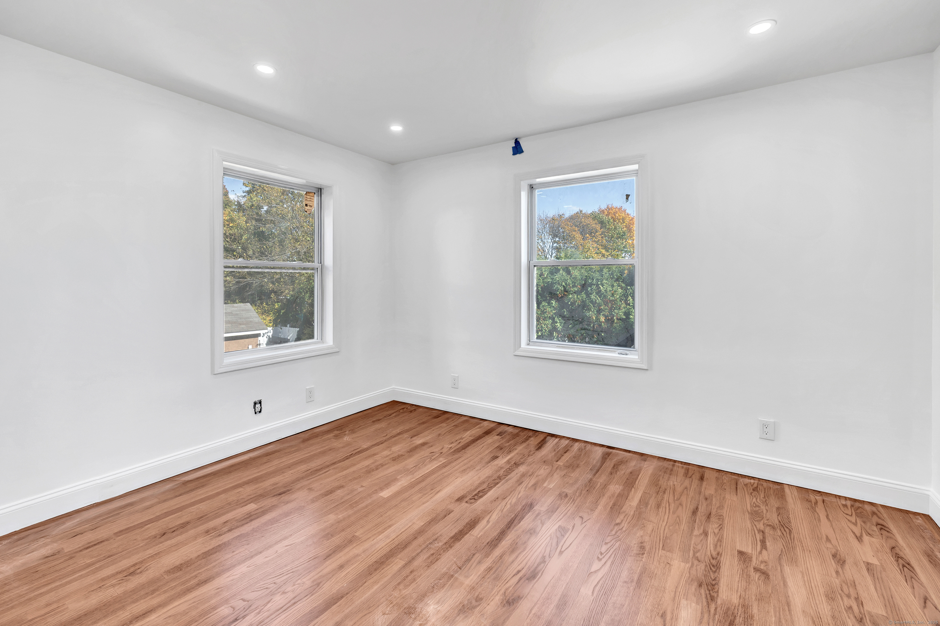 14 Fairview Avenue, Unit B Norwalk, CT 06850 - Photo 20 of 31 an empty room with wooden floor and windows