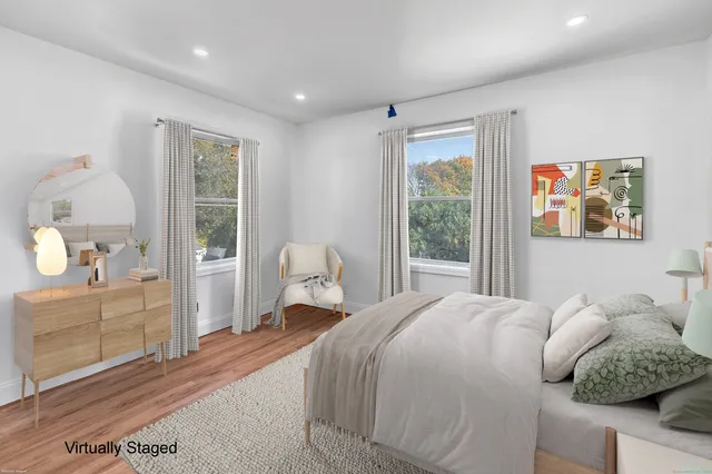 a bedroom with a large bed and a window