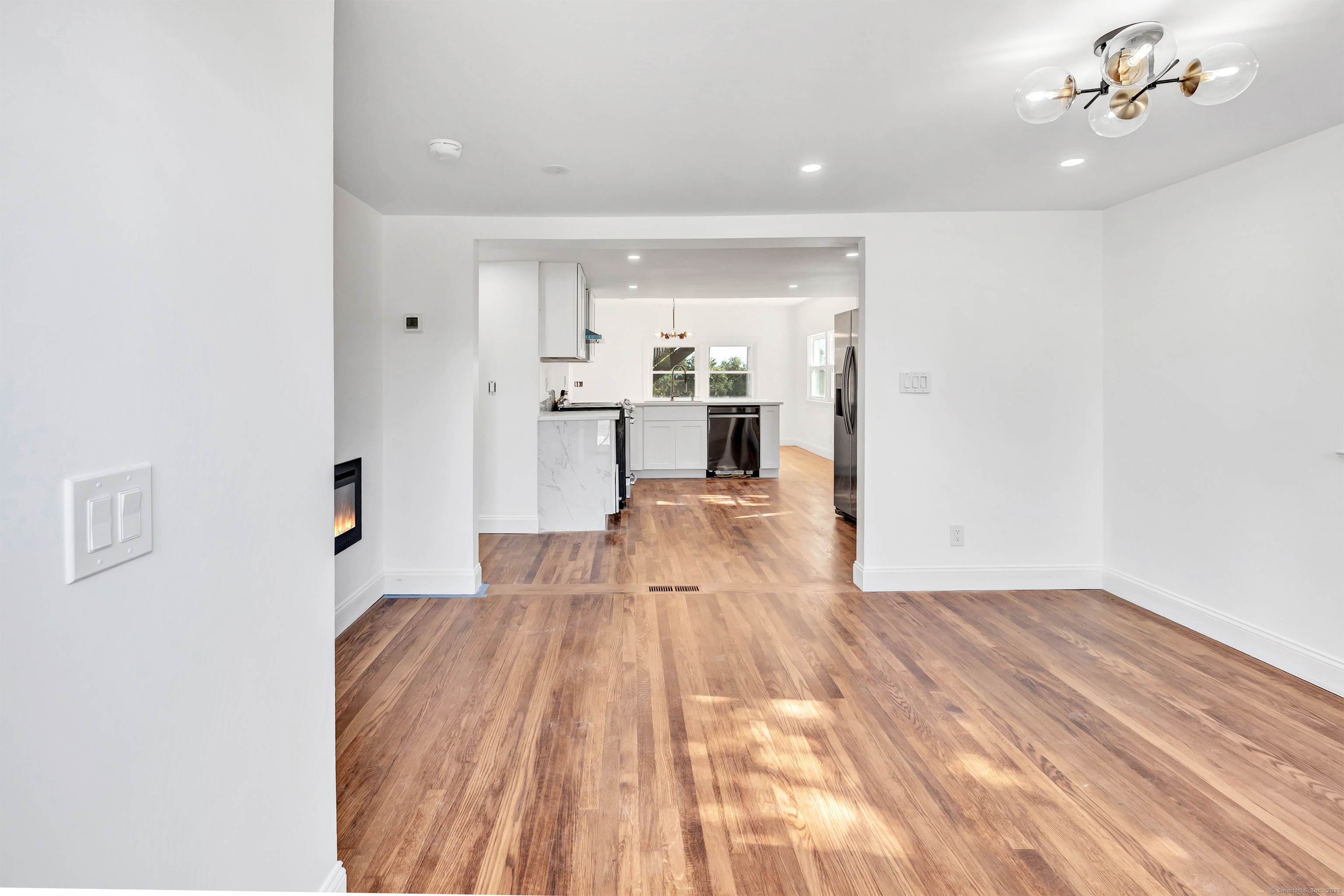 14 Fairview Avenue, Unit B Norwalk, CT 06850 - Photo 7 of 31 a view of a living room with kitchen island stainless steel appliances wooden floor and view living room