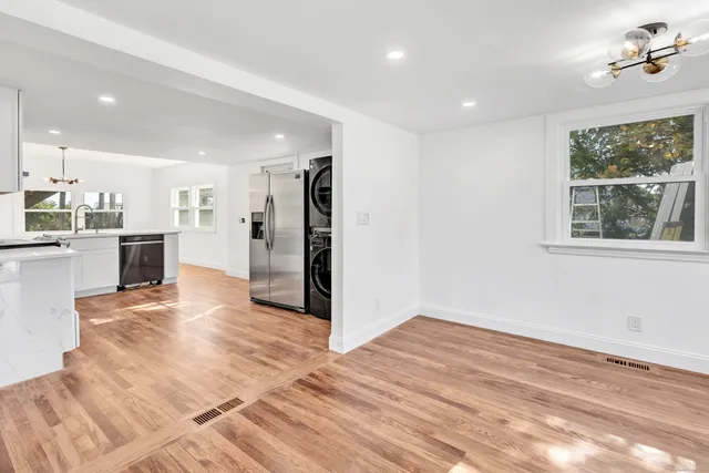 a view of a kitchen with a sink and a refrigerator