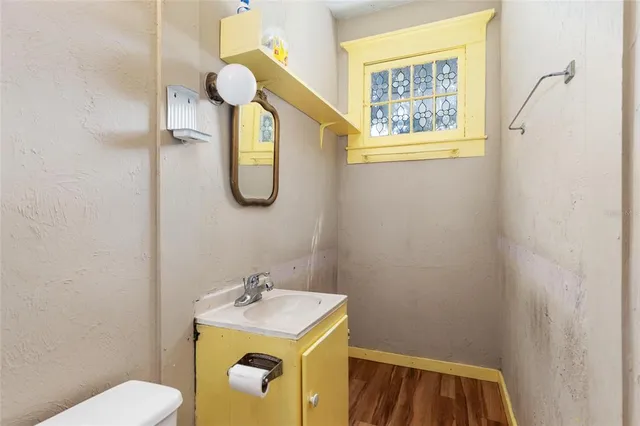 a bathroom with a sink a toilet and mirror