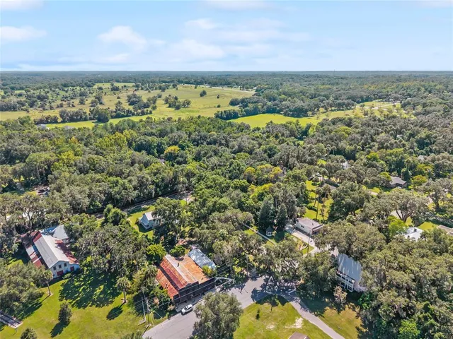 an aerial view of a houses with a yard