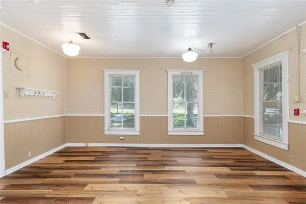 a view of a room with windows and ceiling fan