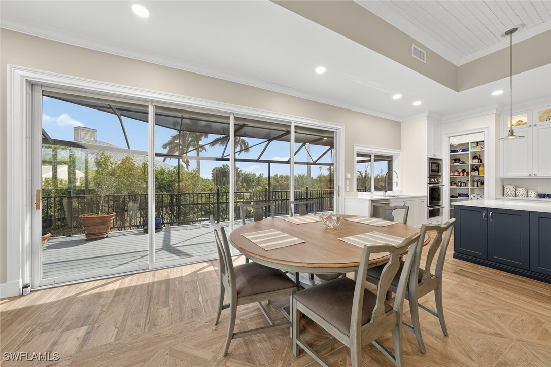 1537 Sand Castle Road Sanibel, FL 33957 - Photo 6 of 50 a view of a dining room with furniture large windows and wooden floor