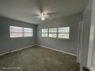 an empty room with closet and a bathroom