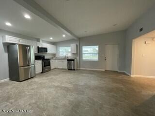 305 Prospect Avenue Cocoa, FL 32922 - Photo 6 of 25 a view of an empty room with a kitchen