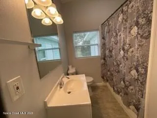 an empty room with sliding glass door and shower