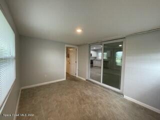 305 Prospect Avenue Cocoa, FL 32922 - Photo 9 of 25 an empty room with sliding glass door and shower