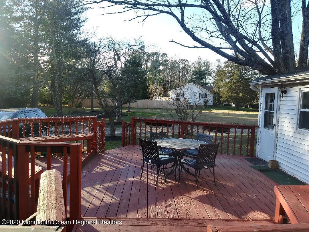 67 Paint Island Spring Road Clarksburg, NJ 08510 - Photo 3 of 8 a view of a chairs and table on the deck