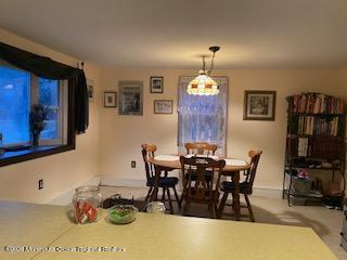 67 Paint Island Spring Road Clarksburg, NJ 08510 - Photo 5 of 8 a view of a dining room with furniture and chandelier