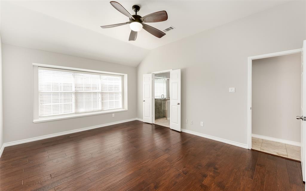 9507 Landmark Place Frisco, TX 75035 - Photo 14 of 18 an empty room with wooden floor fan and windows
