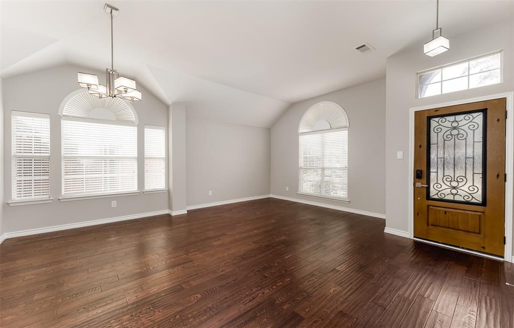 9507 Landmark Place Frisco, TX 75035 - Photo 5 of 18 a view of an empty room with wooden floor and a window