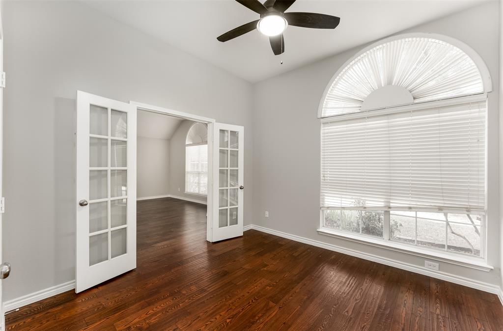 9507 Landmark Place Frisco, TX 75035 - Photo 7 of 18 an empty room with wooden floor fan and windows
