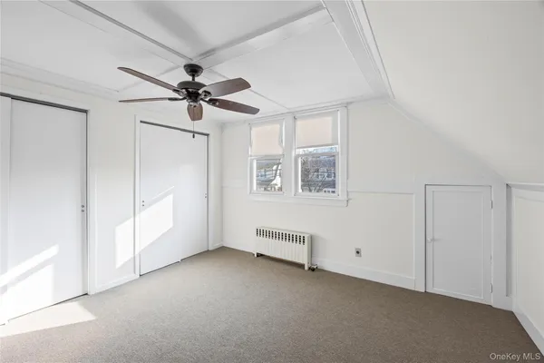 a view of empty room with ceiling fan