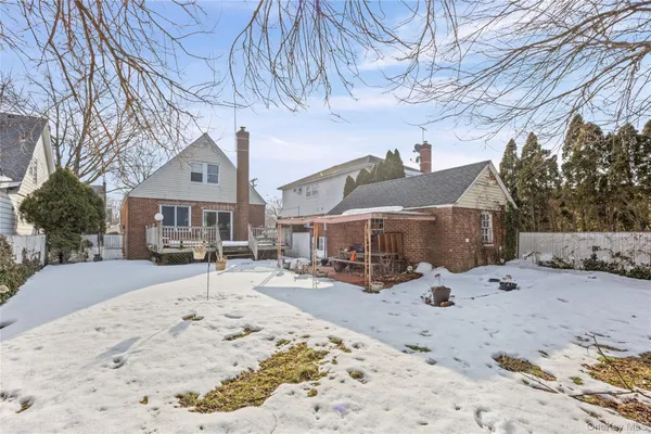a view of a house with a yard covered in snow
