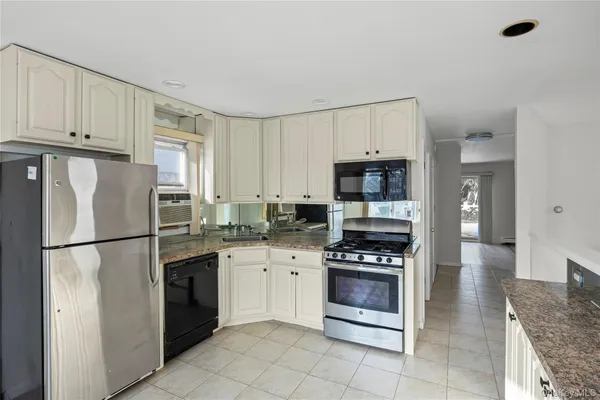 a kitchen with stainless steel appliances a refrigerator sink and cabinets