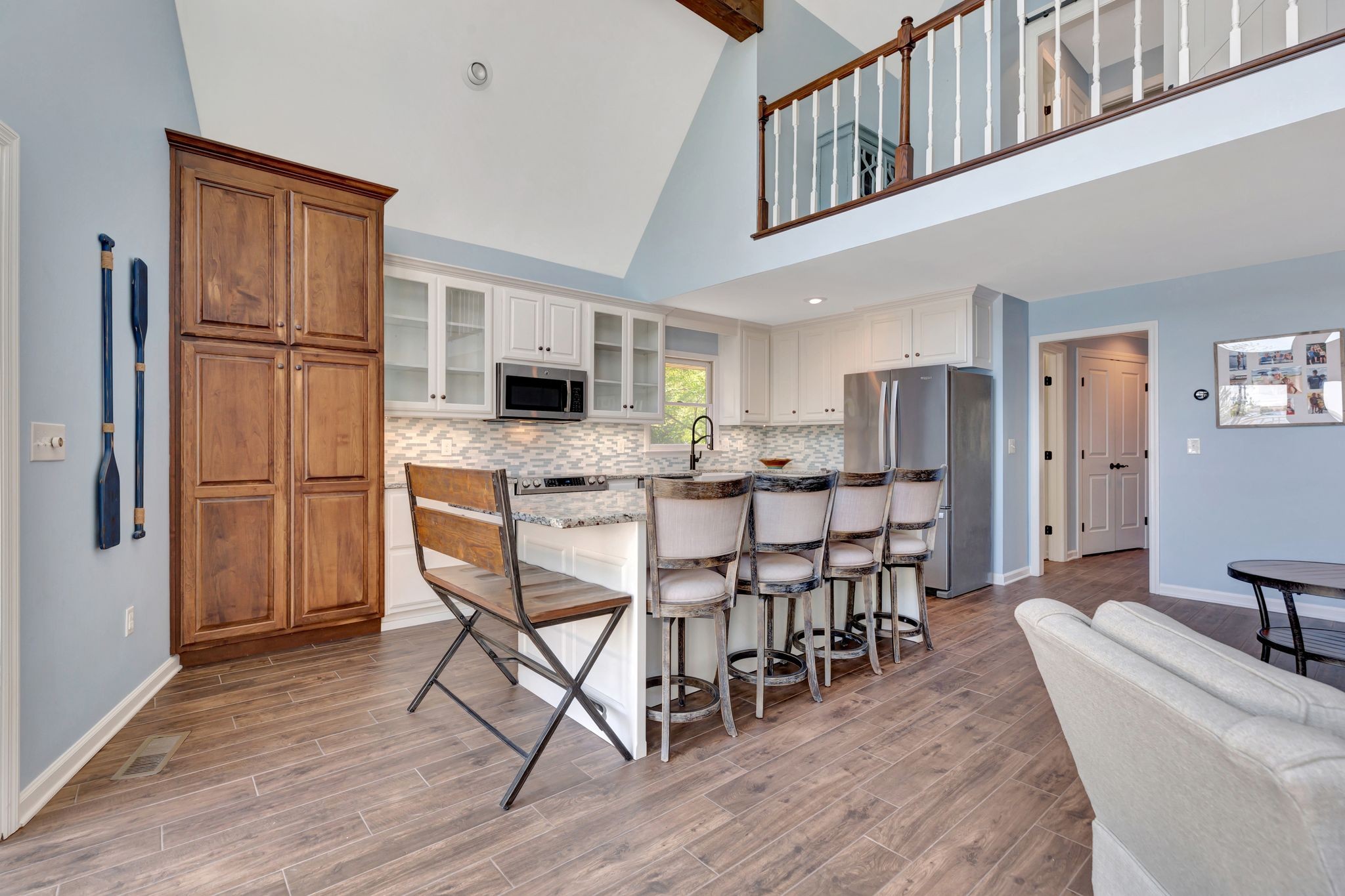 668 Bluff Drive Winchester, TN 37398 - Photo 24 of 55 a kitchen with stainless steel appliances granite countertop a refrigerator a stove a sink a dining table and chairs with wooden floor