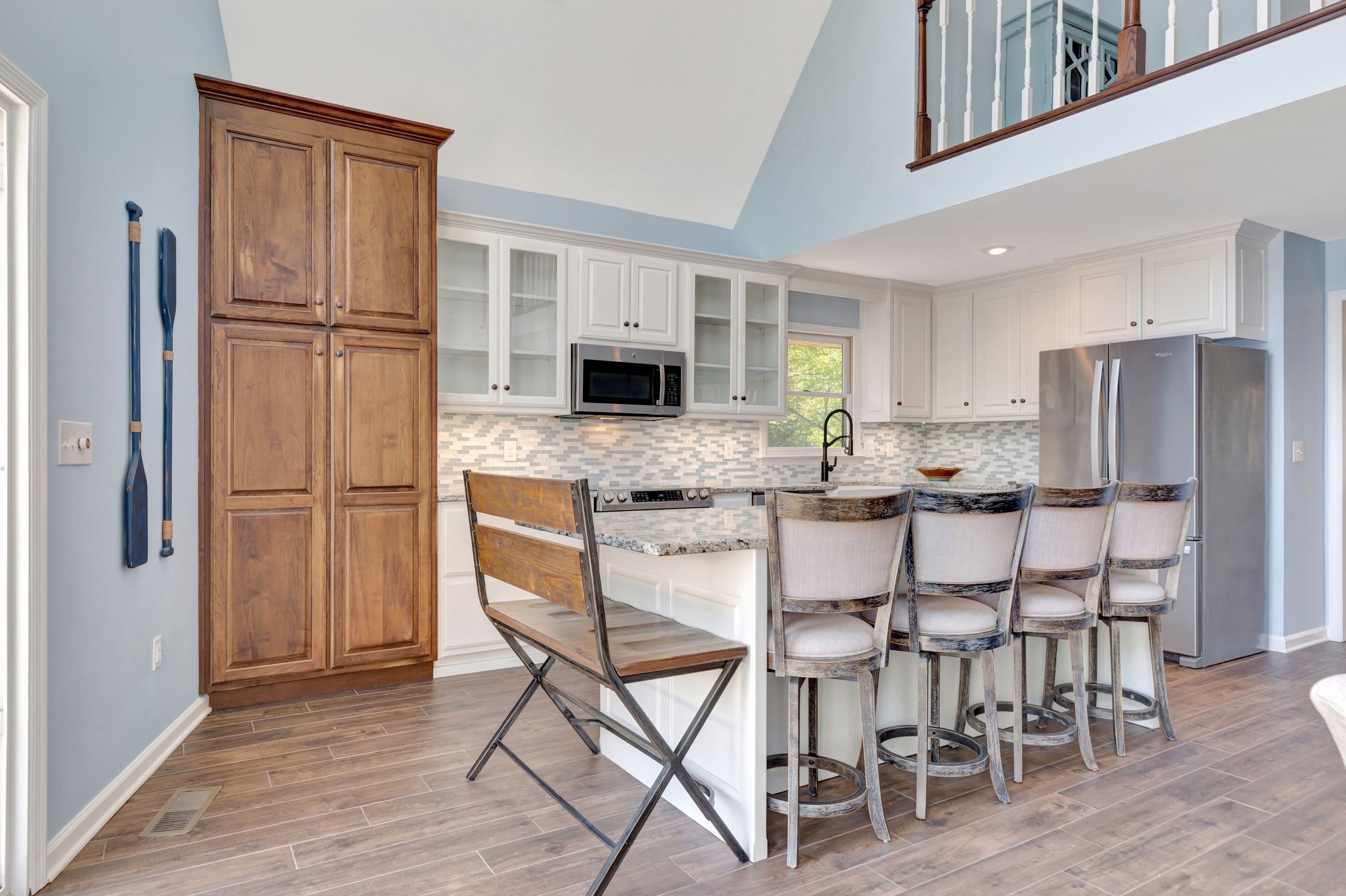 668 Bluff Drive Winchester, TN 37398 - Photo 25 of 55 a kitchen with stainless steel appliances a refrigerator a stove a dining table and chairs with wooden floor