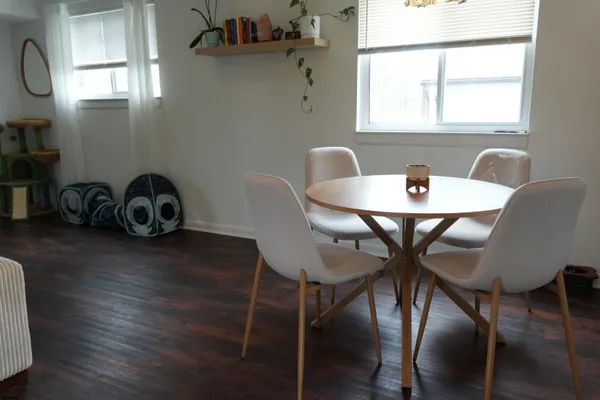 a view of a dining room with furniture and wooden floor