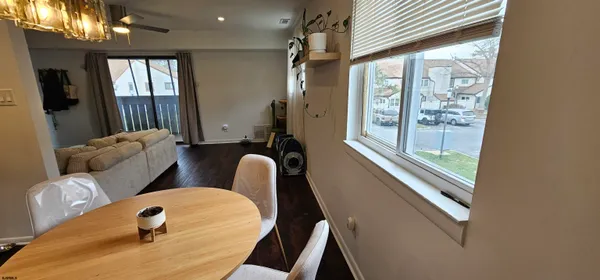 a balcony with chairs and a large window