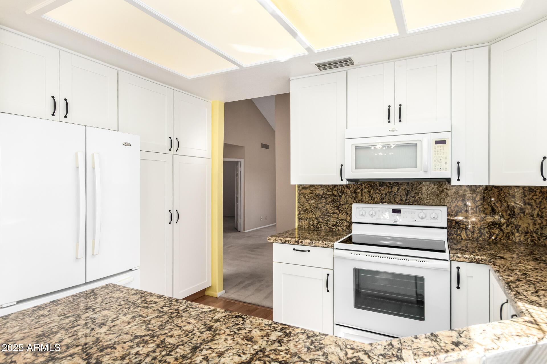 10019 East Mountain View Road, Unit 2114 Scottsdale, AZ 85258 - Photo 11 of 40 a kitchen with a stove and a refrigerator