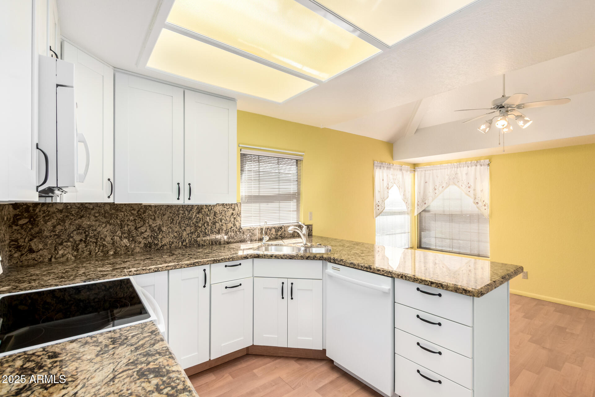 10019 East Mountain View Road, Unit 2114 Scottsdale, AZ 85258 - Photo 12 of 40 a kitchen with granite countertop a sink and a stove