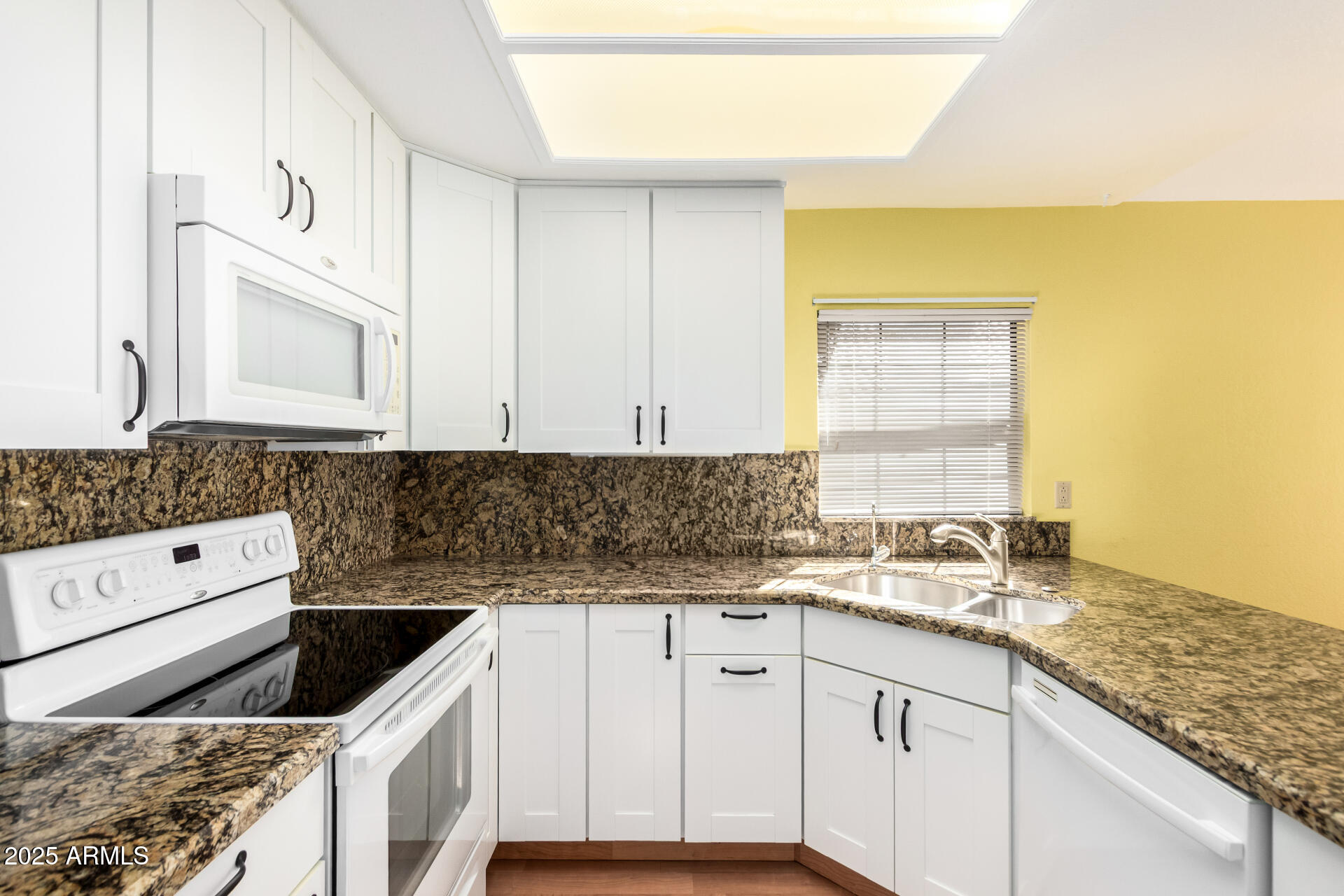 10019 East Mountain View Road, Unit 2114 Scottsdale, AZ 85258 - Photo 13 of 40 a kitchen with granite countertop a sink and a stove