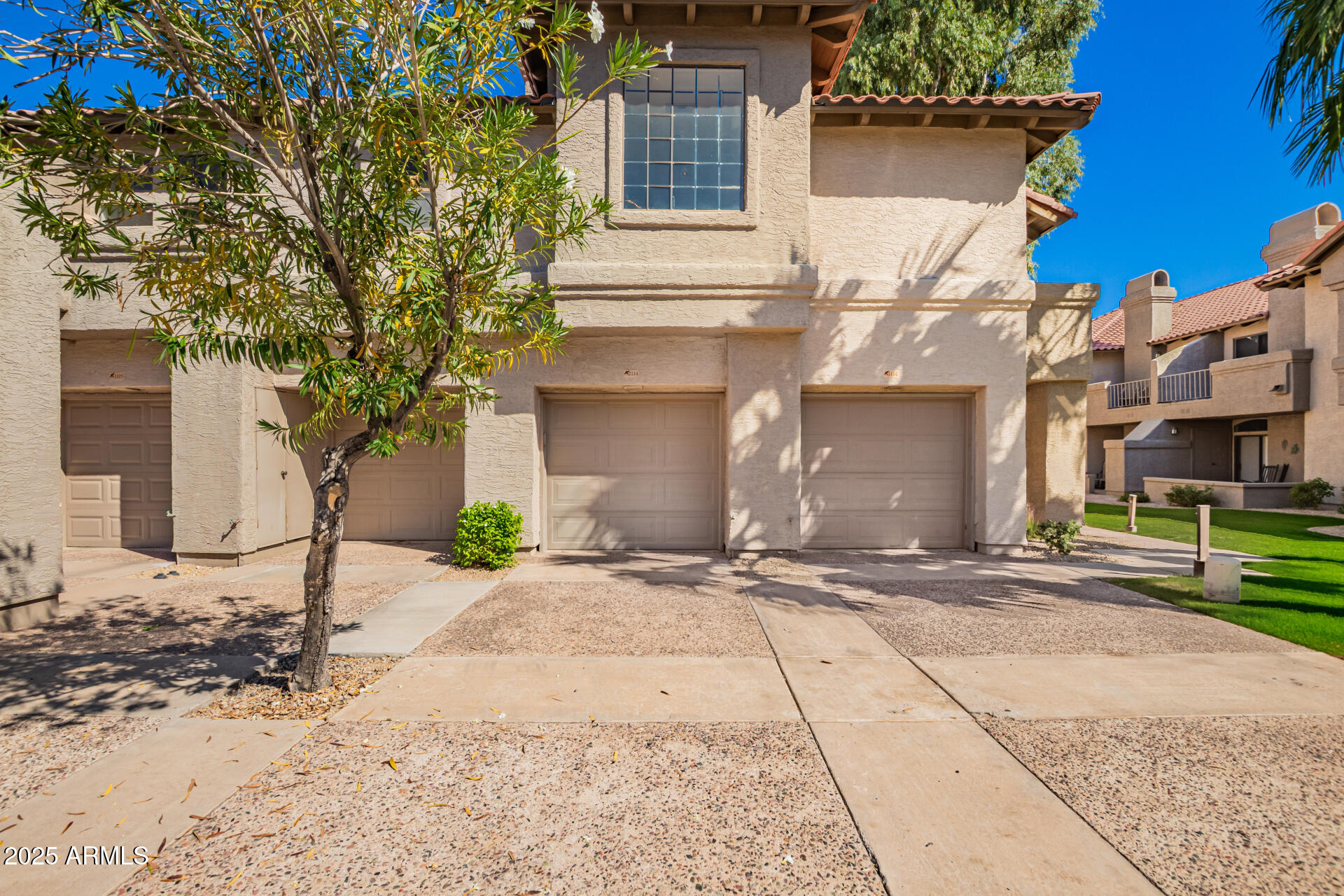10019 East Mountain View Road, Unit 2114 Scottsdale, AZ 85258 - Photo 2 of 40 a front view of a house with a yard