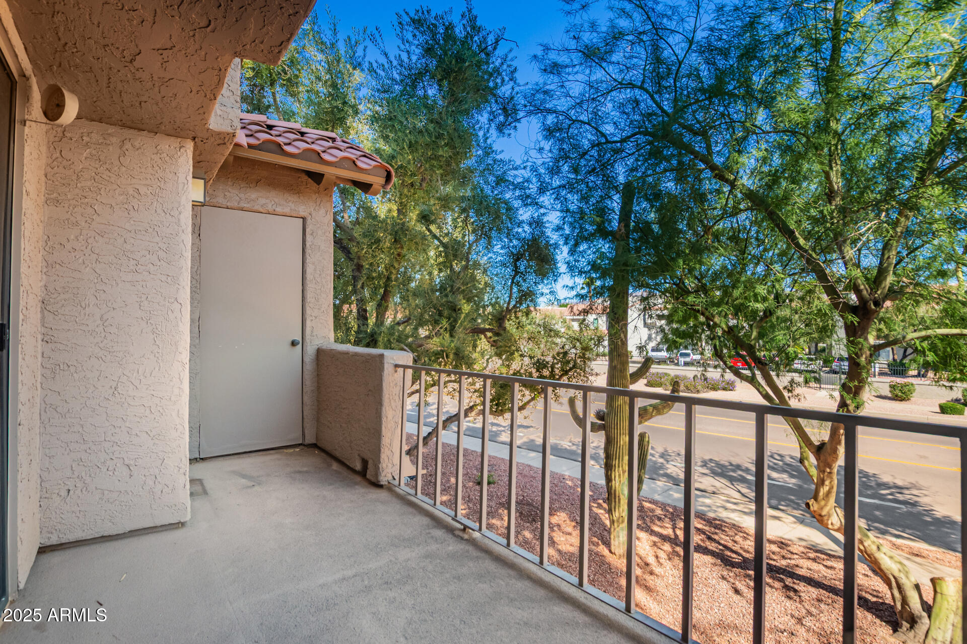10019 East Mountain View Road, Unit 2114 Scottsdale, AZ 85258 - Photo 25 of 40 a view of a house with a tree and wooden fence