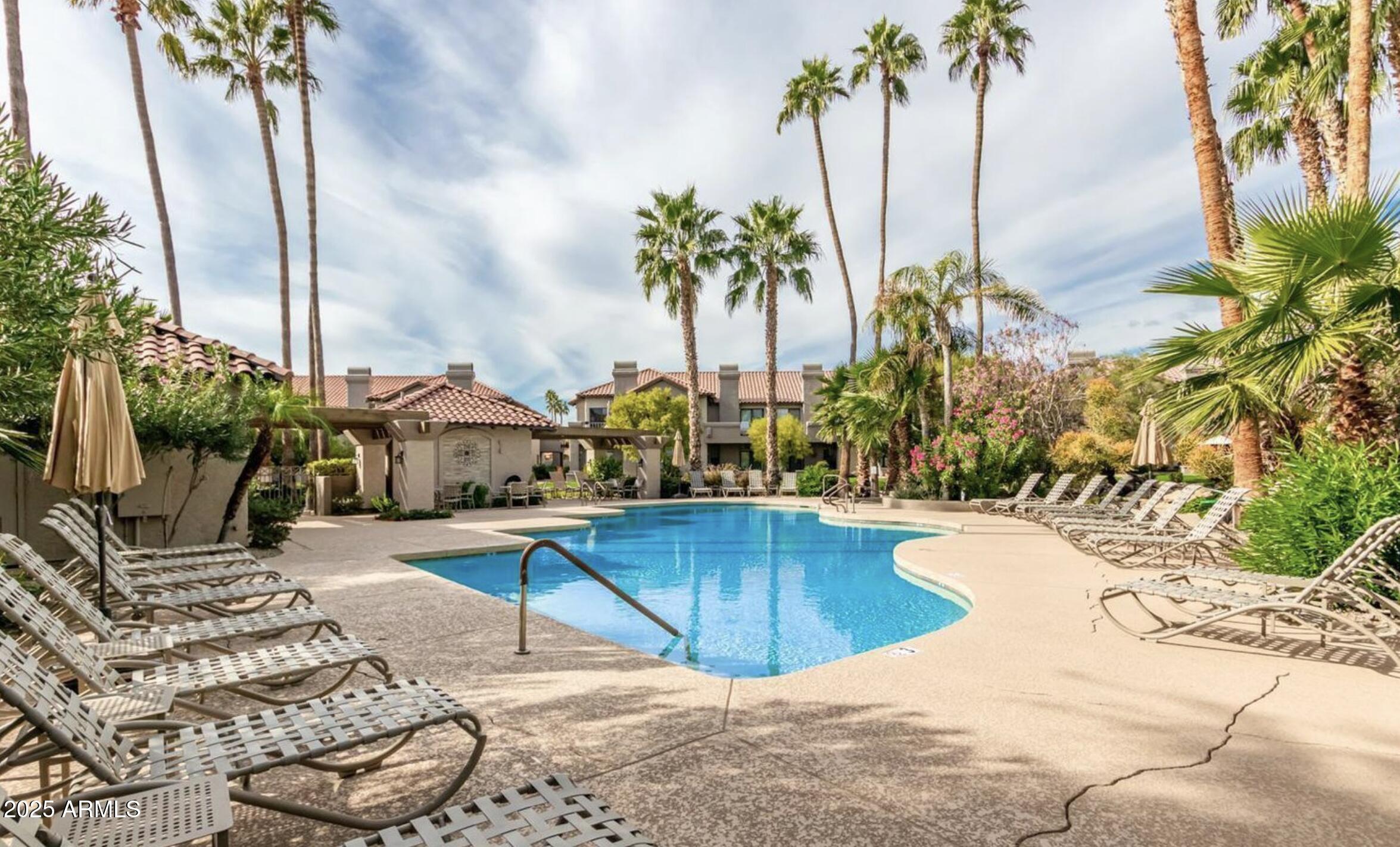 10019 East Mountain View Road, Unit 2114 Scottsdale, AZ 85258 - Photo 32 of 40 a view of a swimming pool with a lounge chair