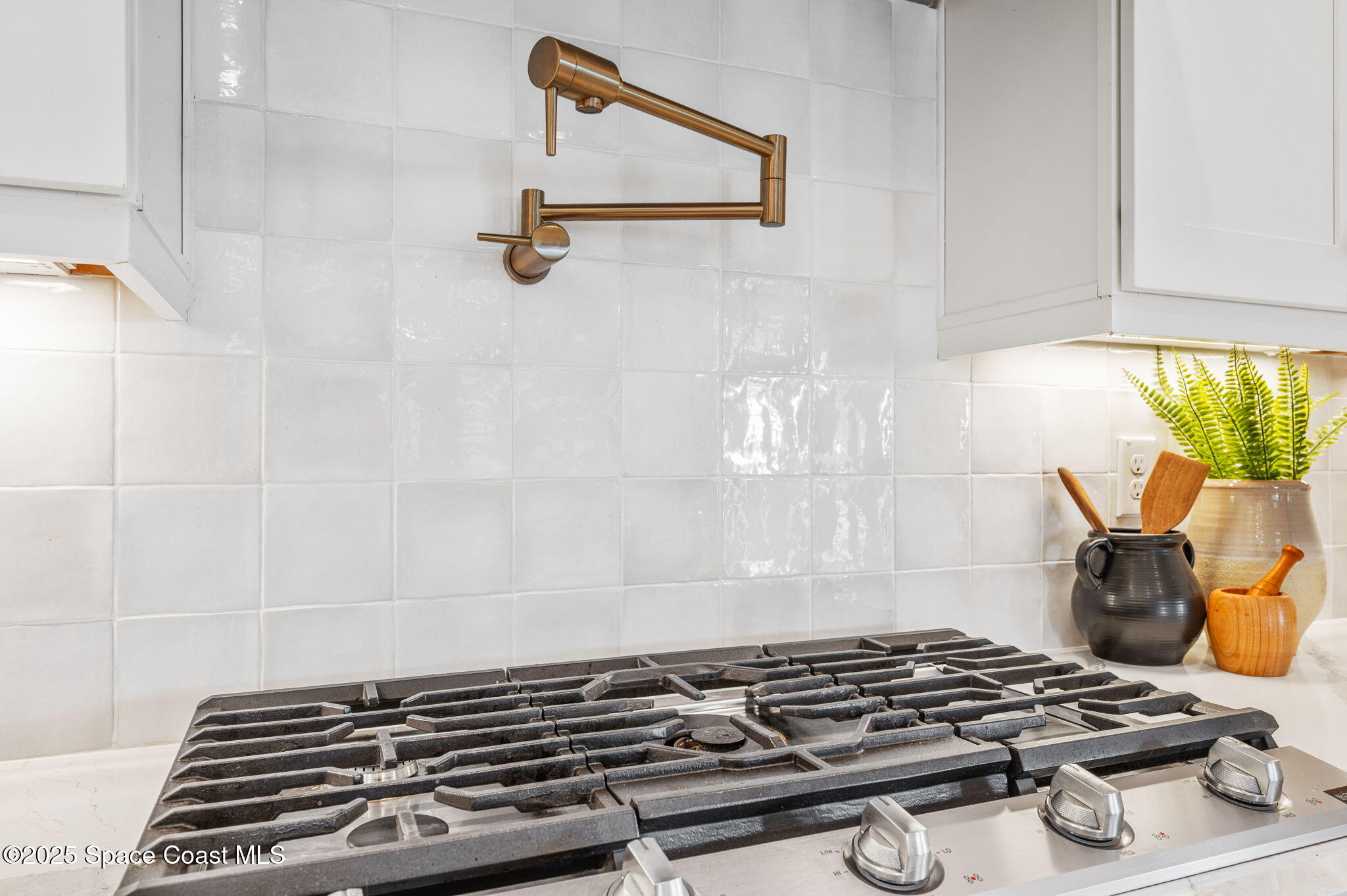2444 Addison Drive Melbourne, FL 32940 - Photo 21 of 93 a close view of a stove a microwave and wooden floor