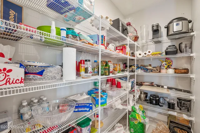a bedroom with a bed and a dresser next to a window